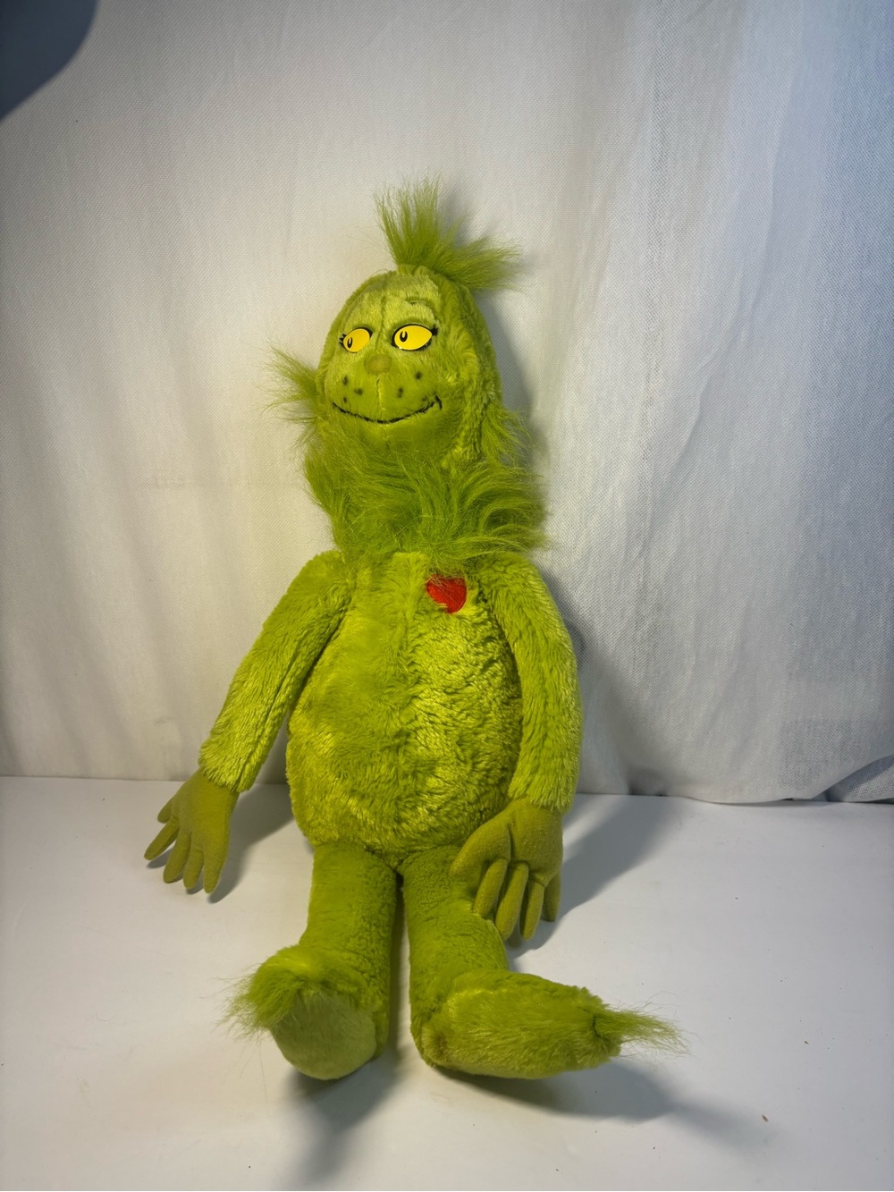 Grinch Plush Character with Yellow Eyes and Red Heart